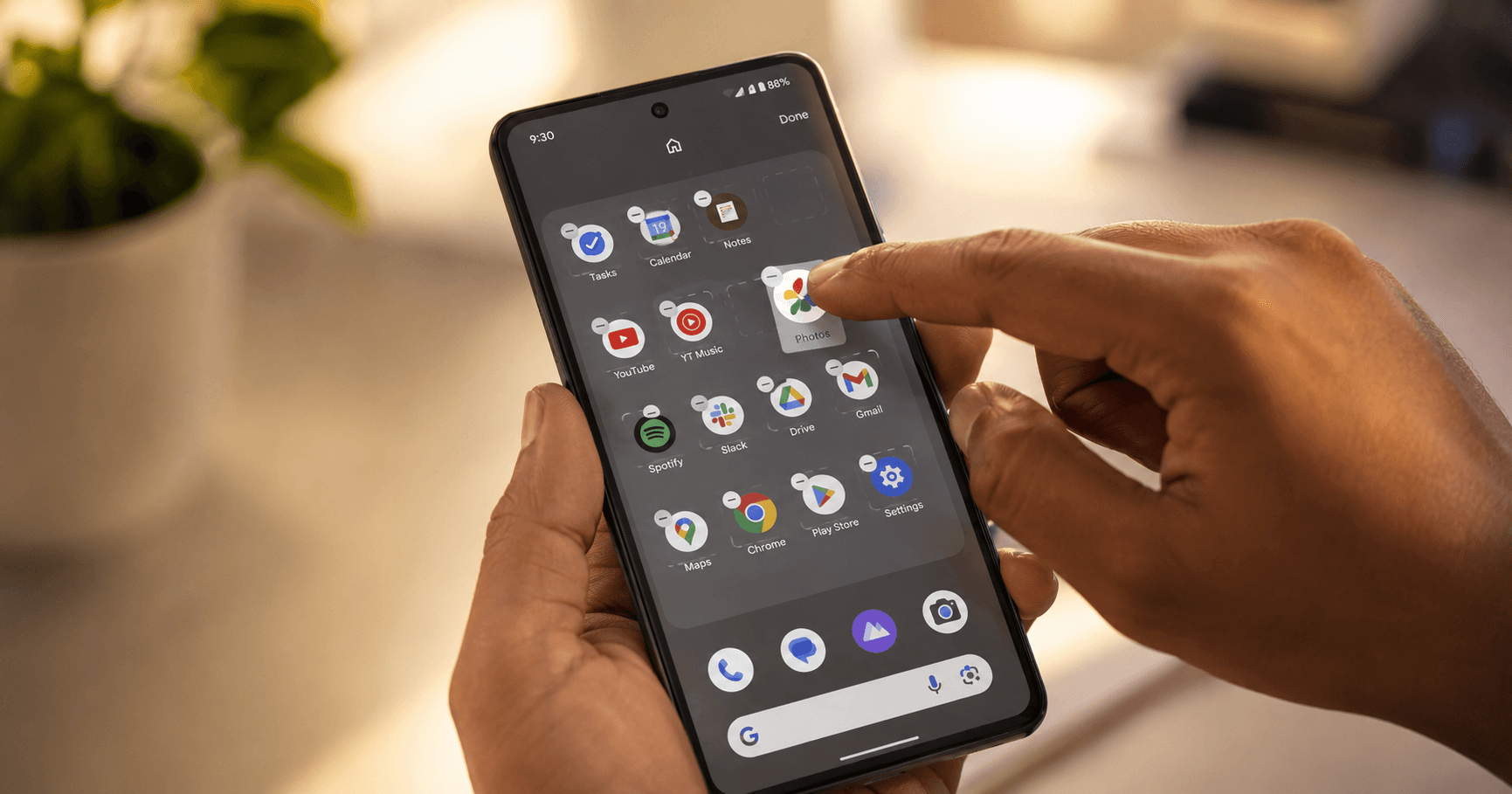 Android phone on a desk showing an organized home screen of  apps, representing a deliberately curated set of tools rather  than app clutter
