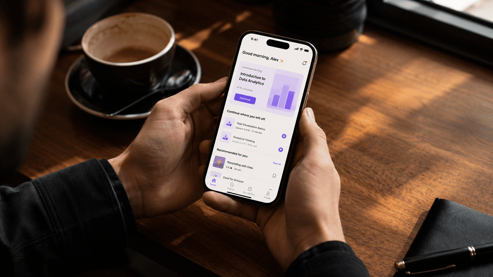 Person learning on their phone during a coffee break, Morso microlearning app open