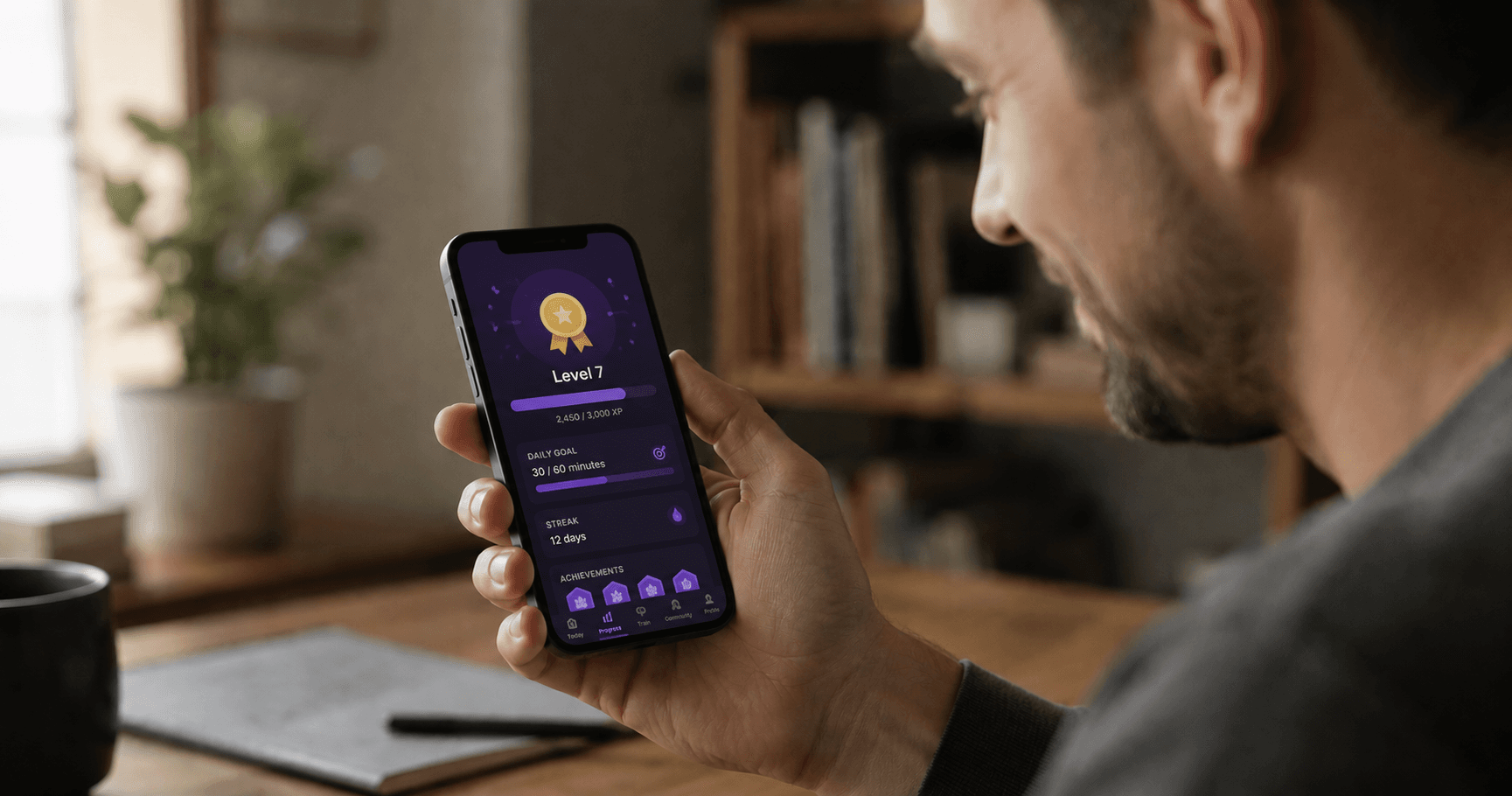 Person looking at a phone showing a progress and achievement
